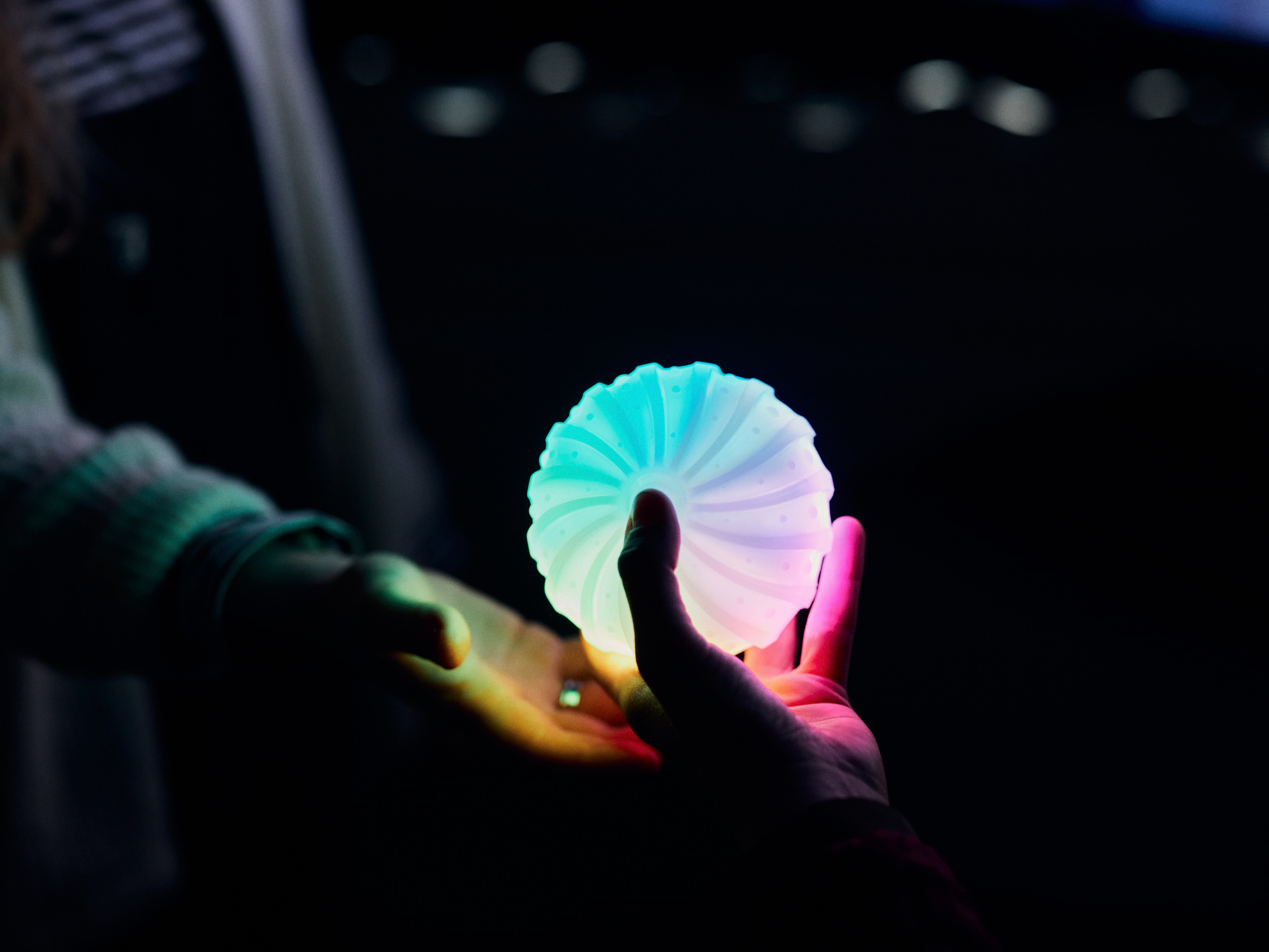 Woman stands in front of virtual robot head Flobi