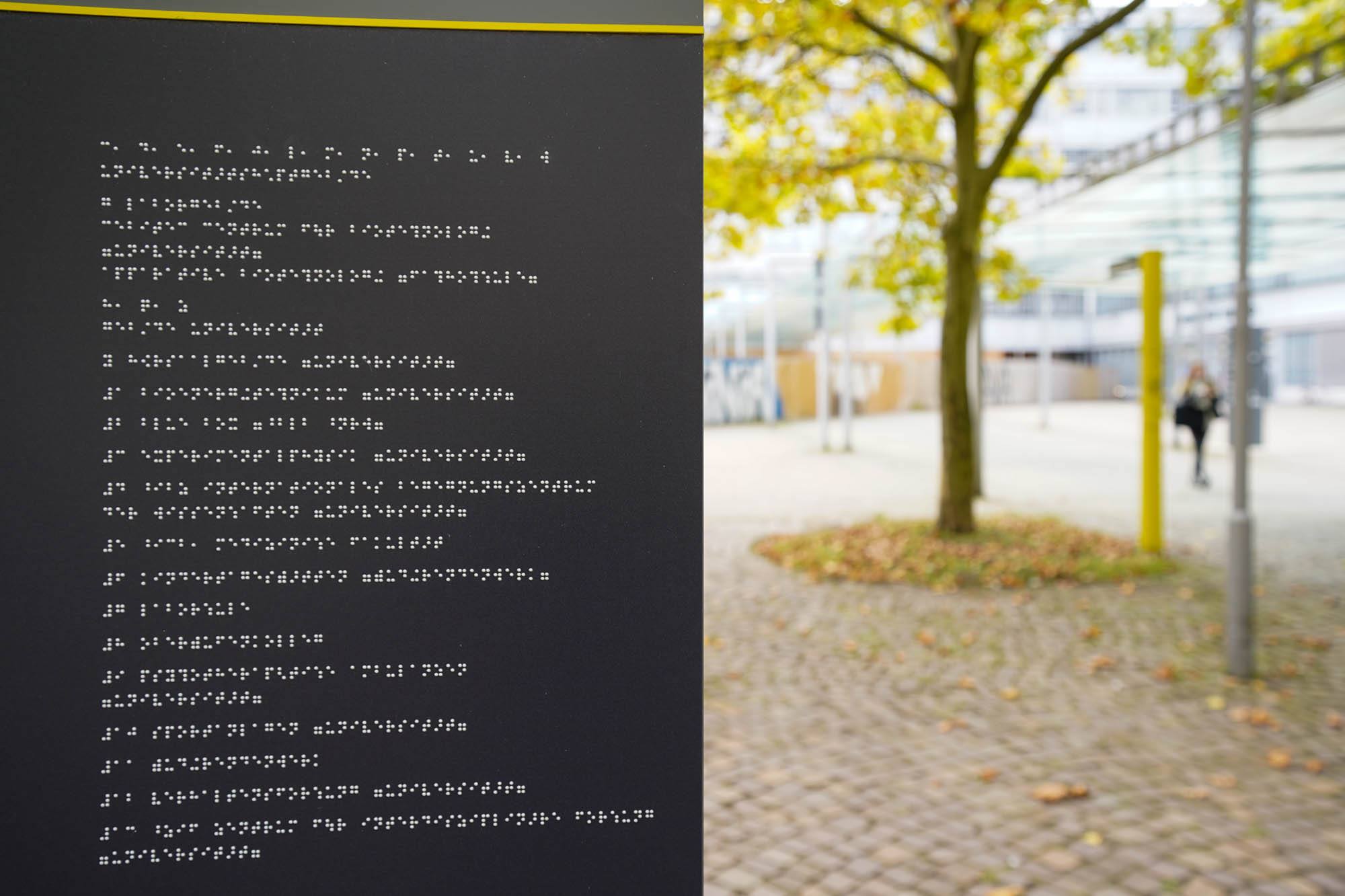 Braille board in front of the entrance to the university