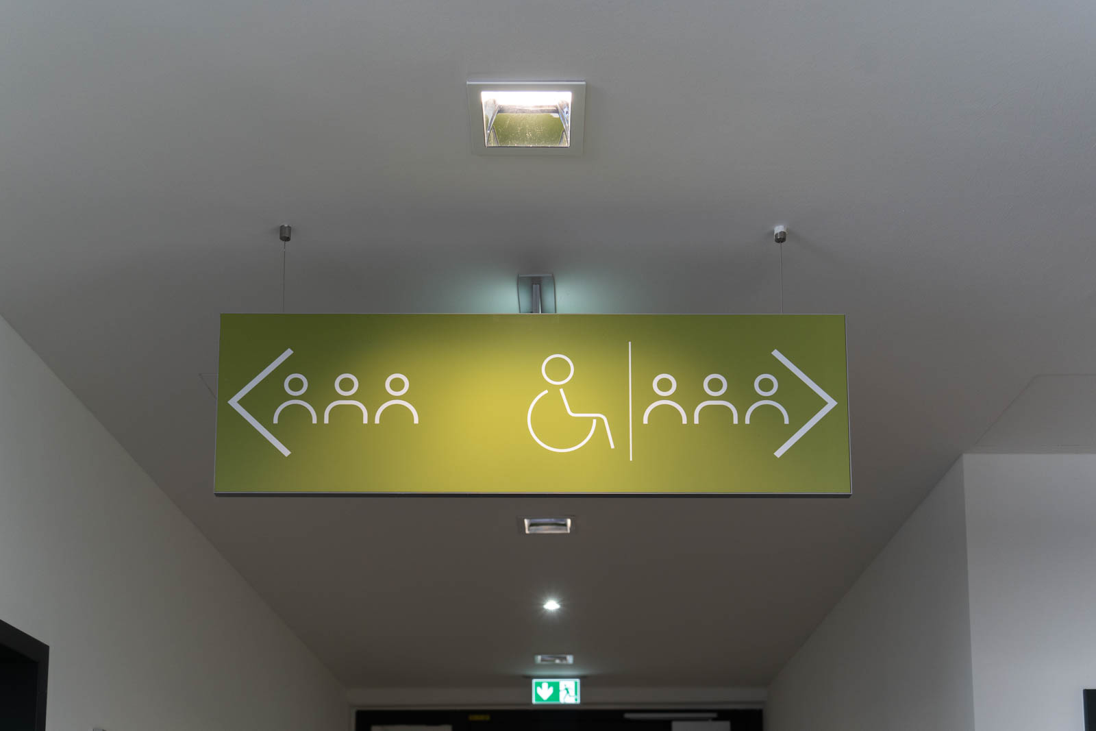 Green signboard with wheelchair user sign