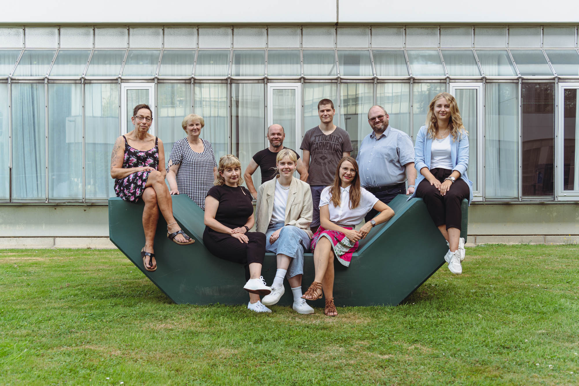 the team sits together on a green seat