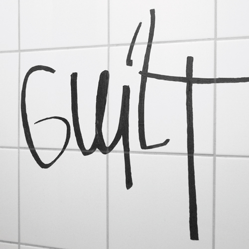 Picture of a graffity of the word "Guilt"