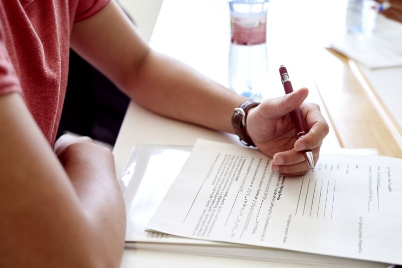 Someone who is writing on a paper