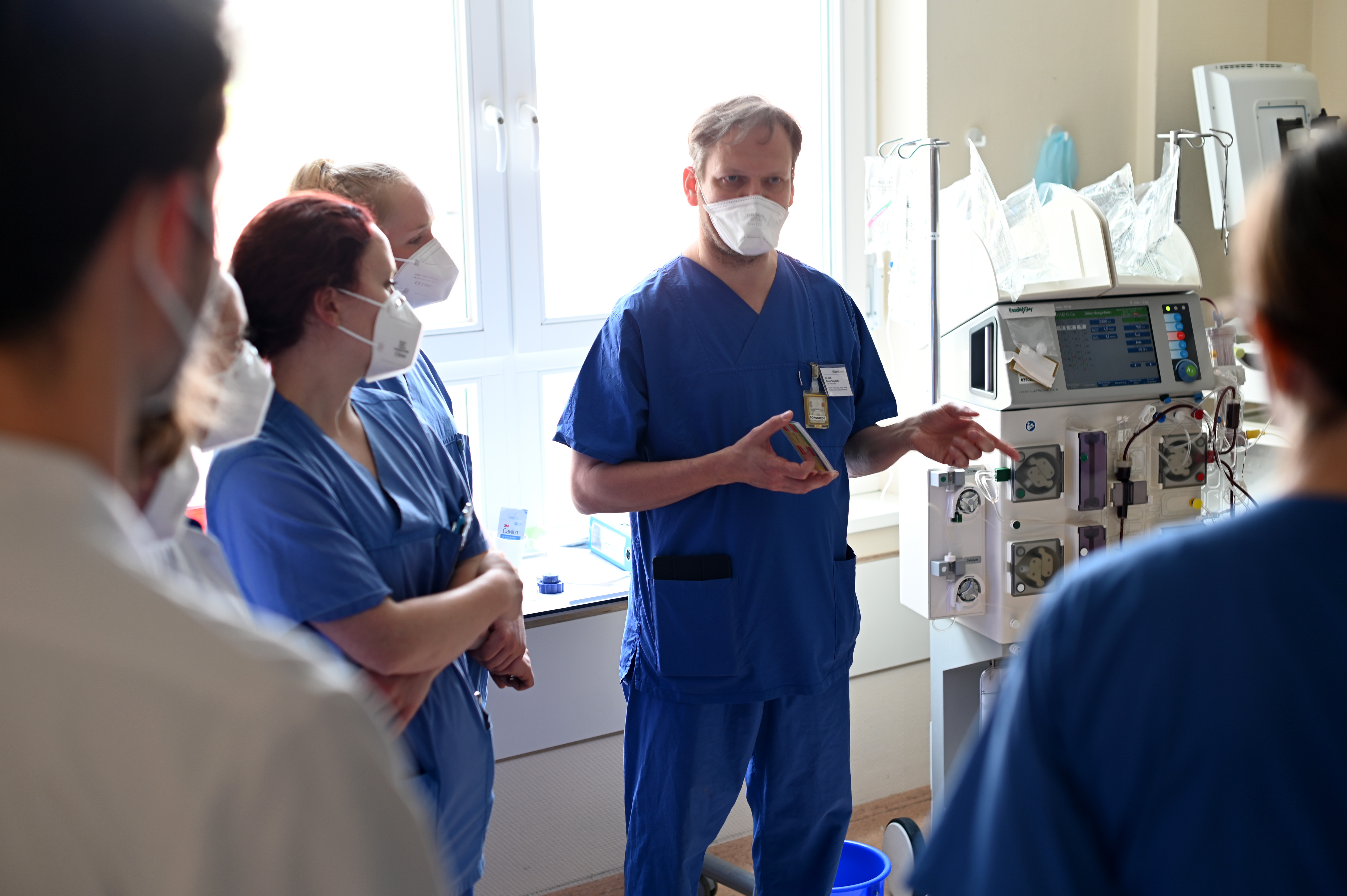 Doctor Sebastian Rehberg talking to medical staff