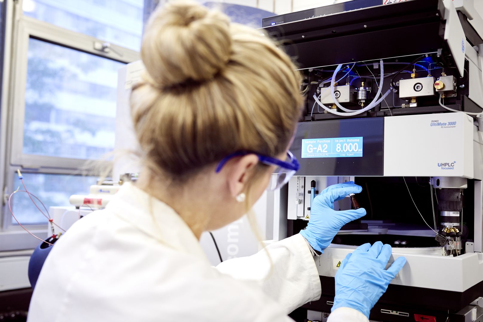 Researcher examines lab sample