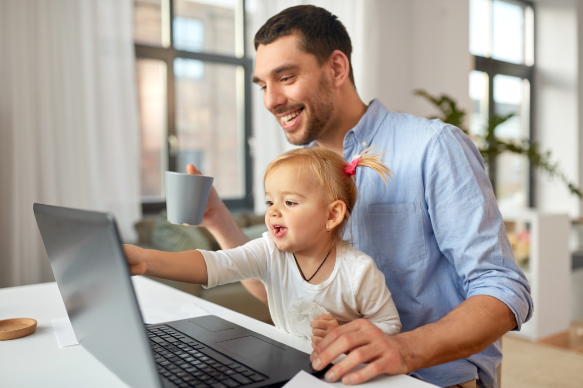 Father with child in home office