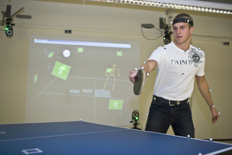 A table tennis player inside a motion capture environment