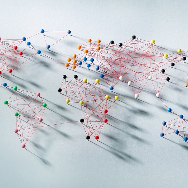Map made of pins on paper connected by red thread