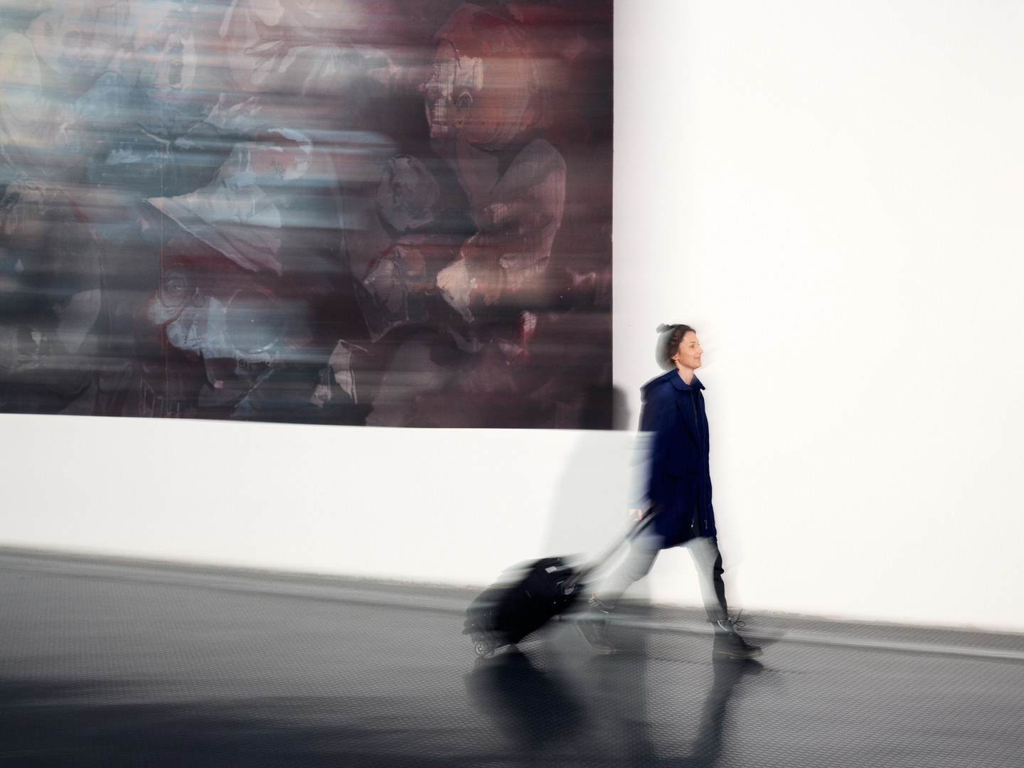 A man and a woman walk through the university hall
