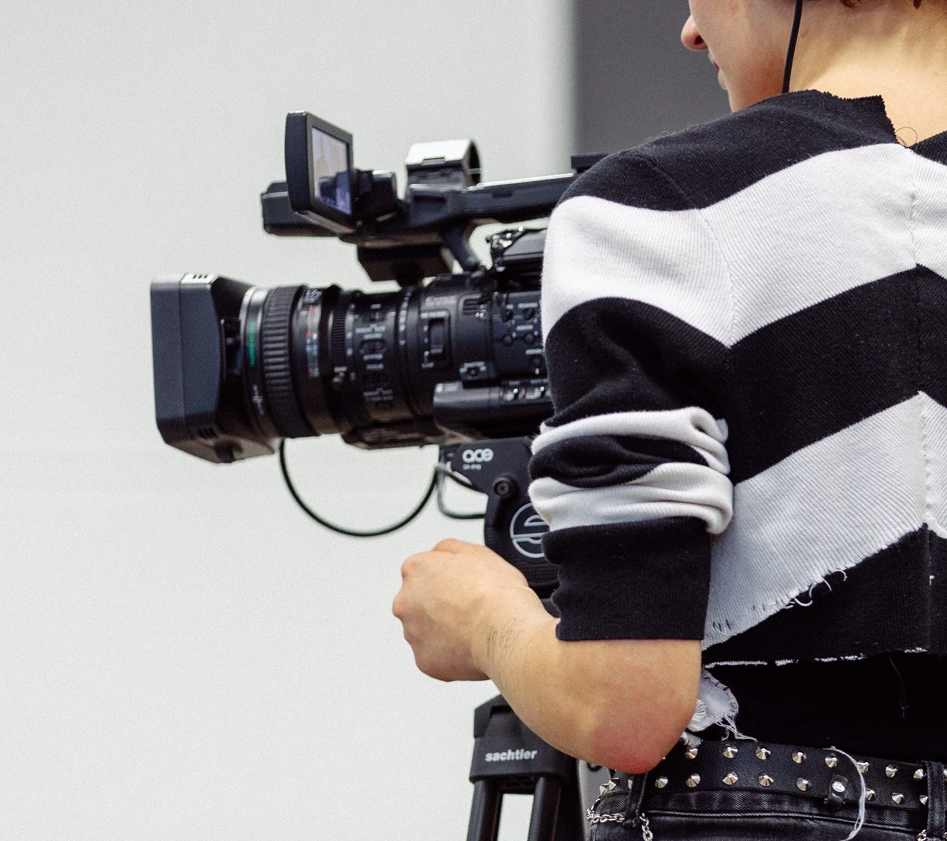Back view of a person operating a film camera