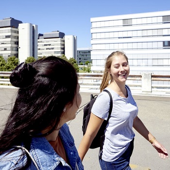 Two young women walking on the roof of the car park