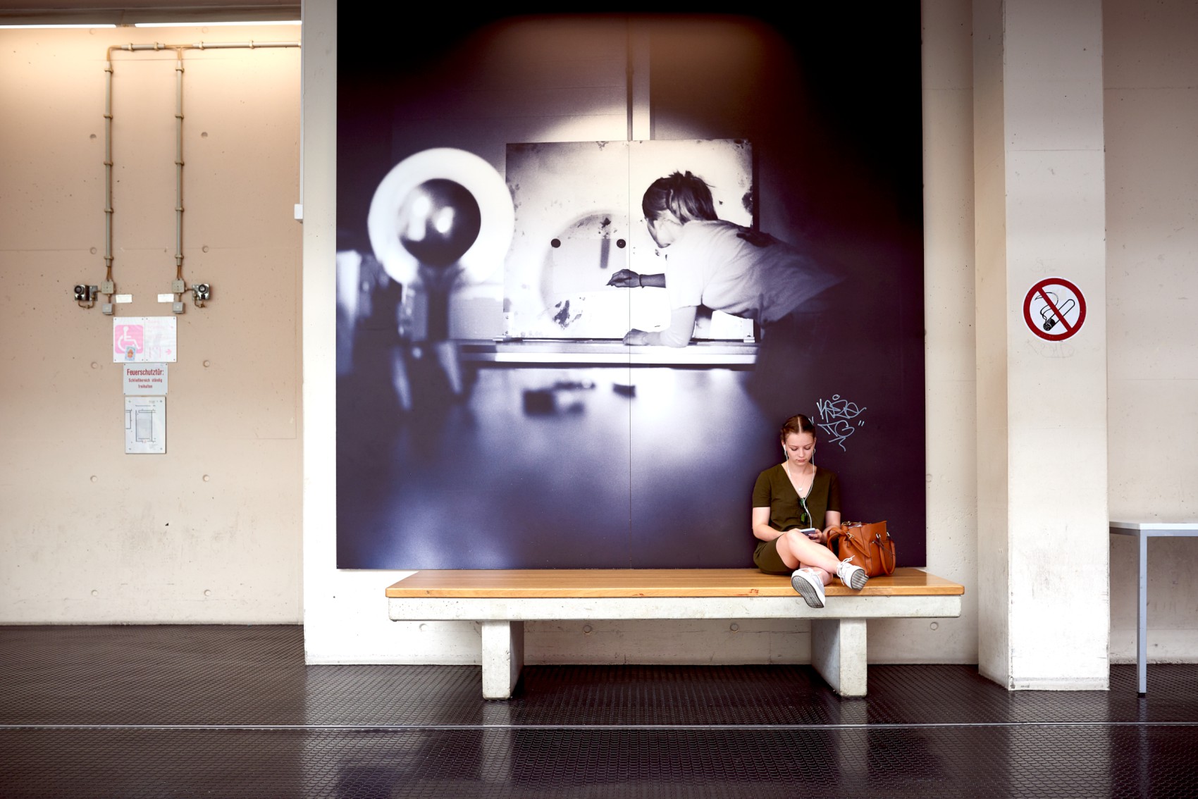 student sitting in front of a photograph 