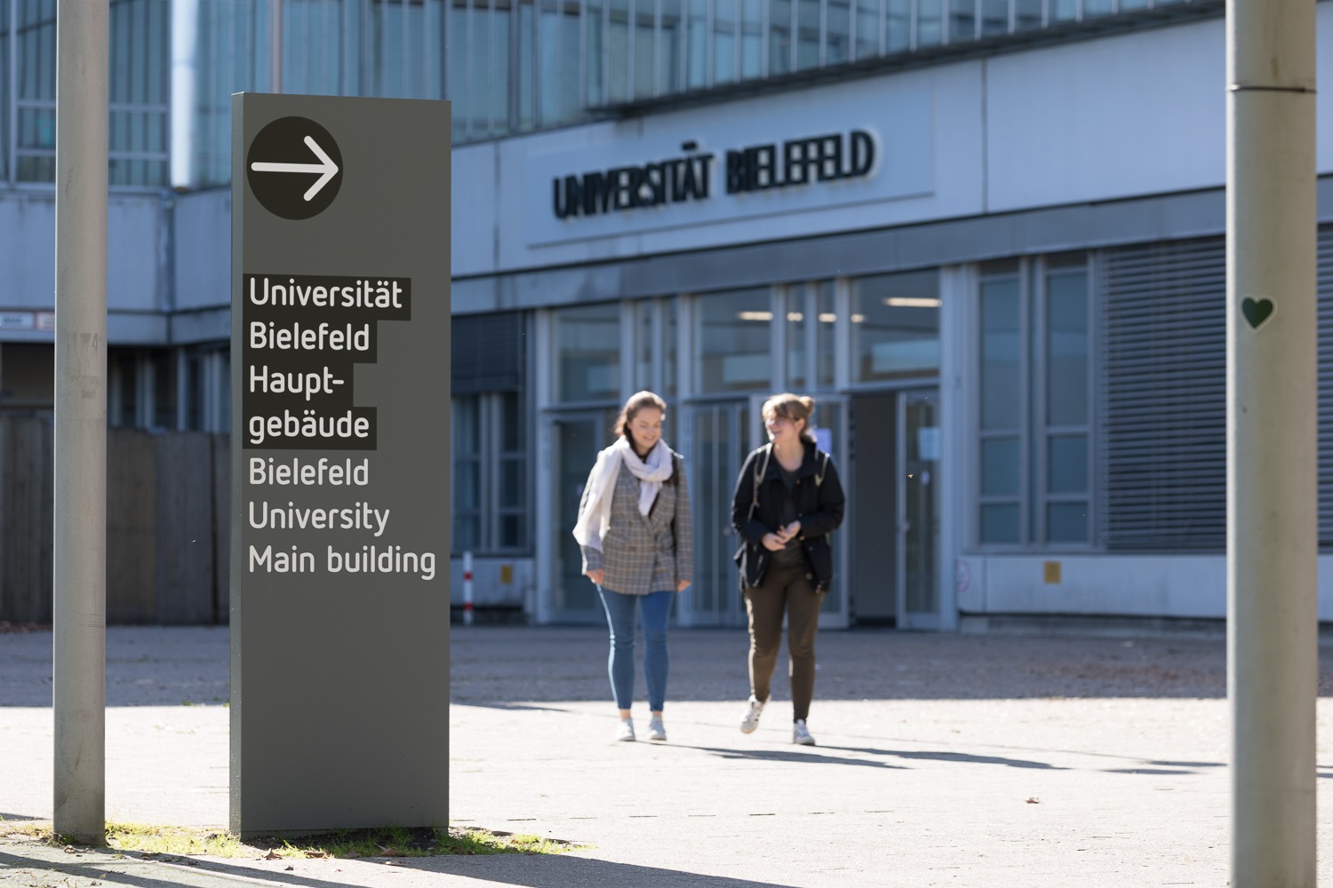 two students in front of main entrance of bielefeld university