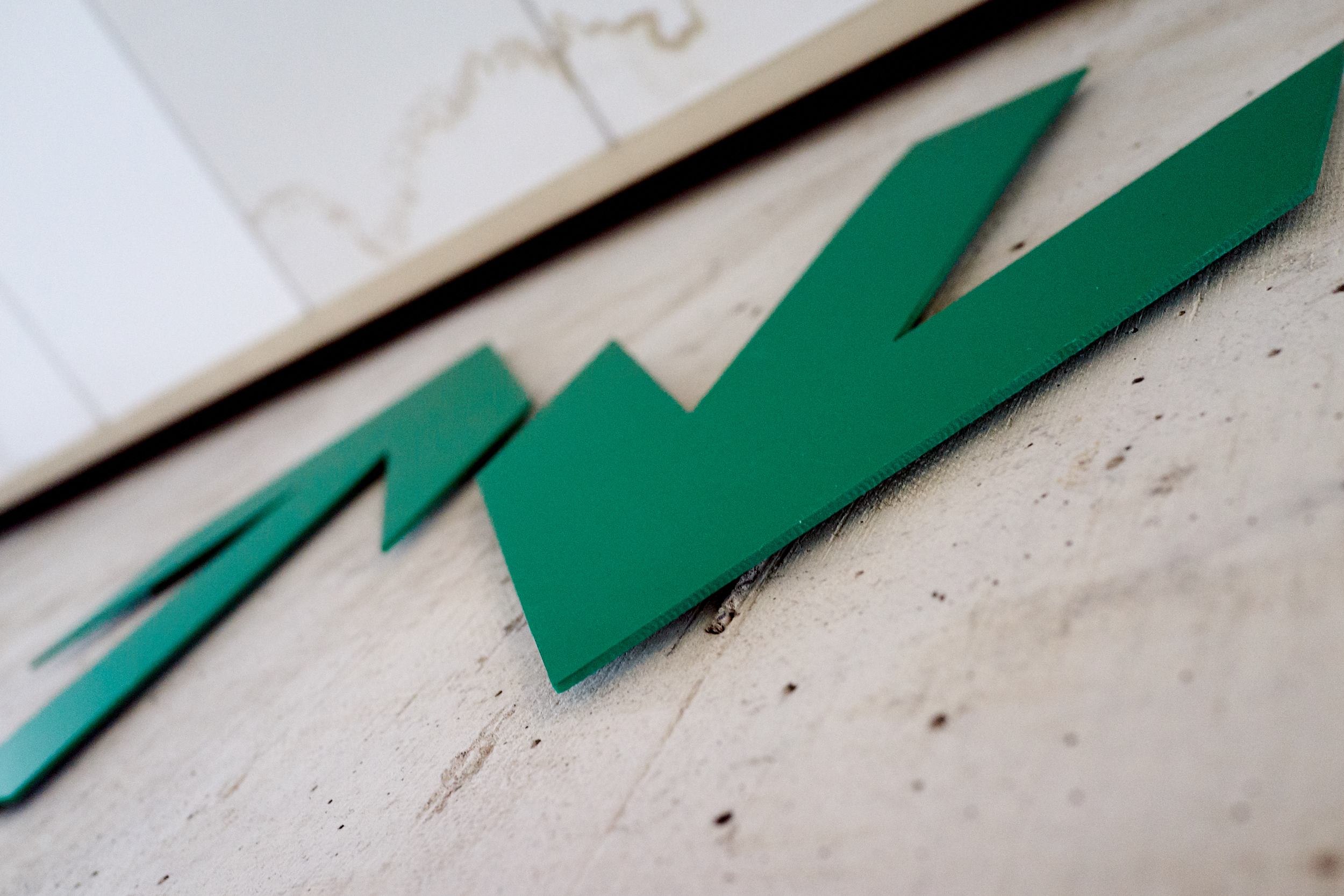 Green arrows on concrete wall